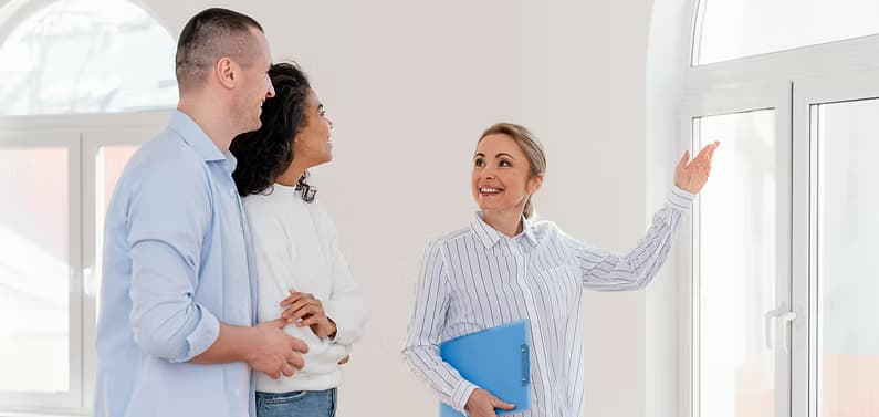 Licensed realtor showing a rental home to a young couple